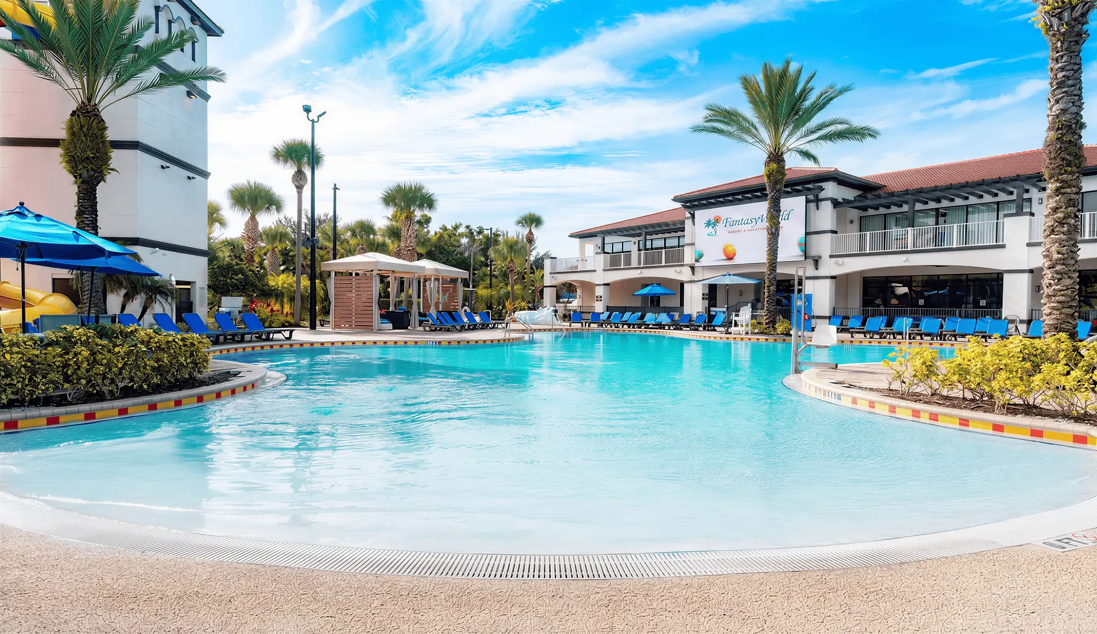 Wide main pool with cabana, lounge chairs, and clubhouse