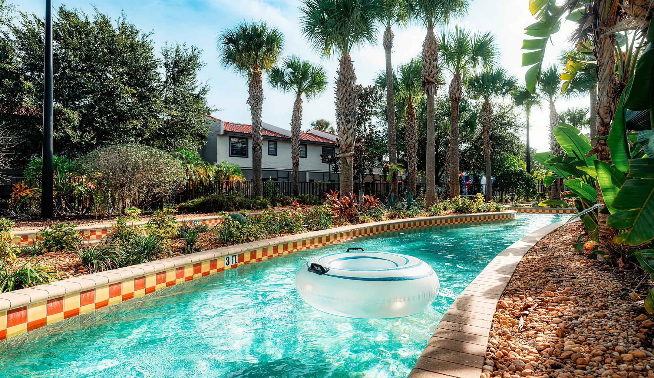 Heated Lazy River with an inflatable tube floating past townhomes