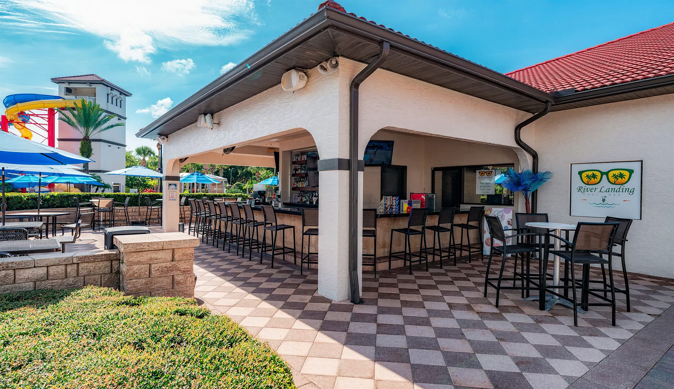 River Landing pool bar with covered seating and water slide views