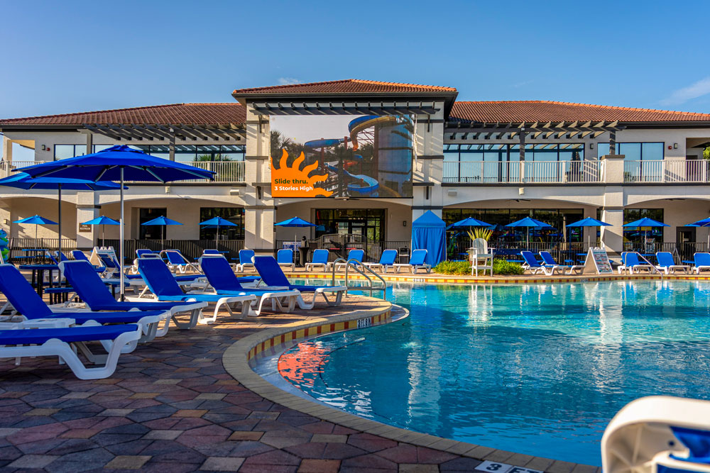 Pool loungers near cabanas overlooking the main pool